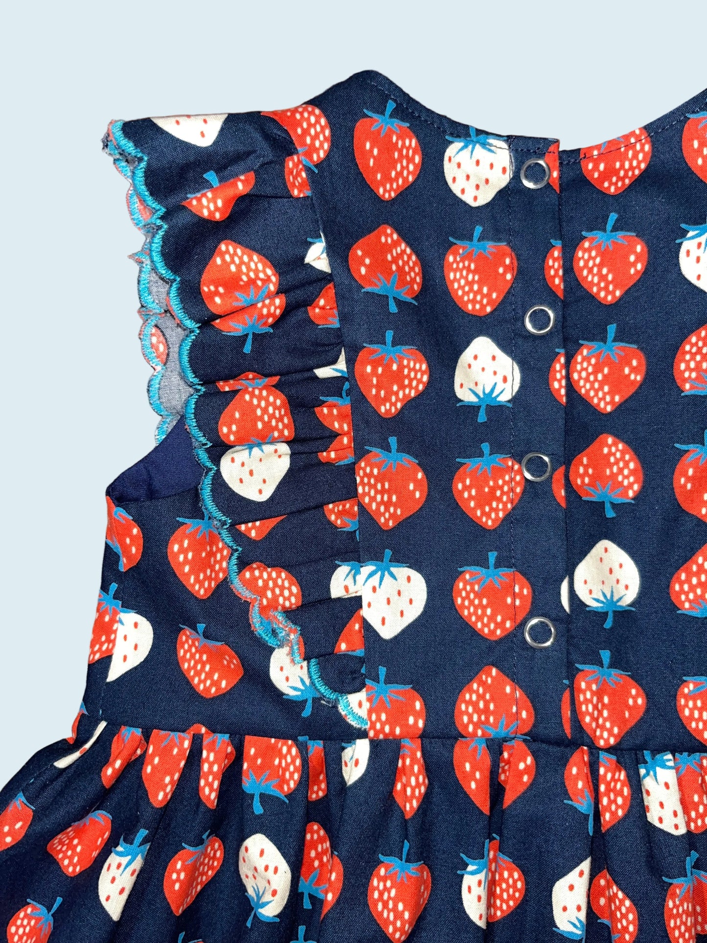 Navy blue fabric with red and white strawberry pattern.
