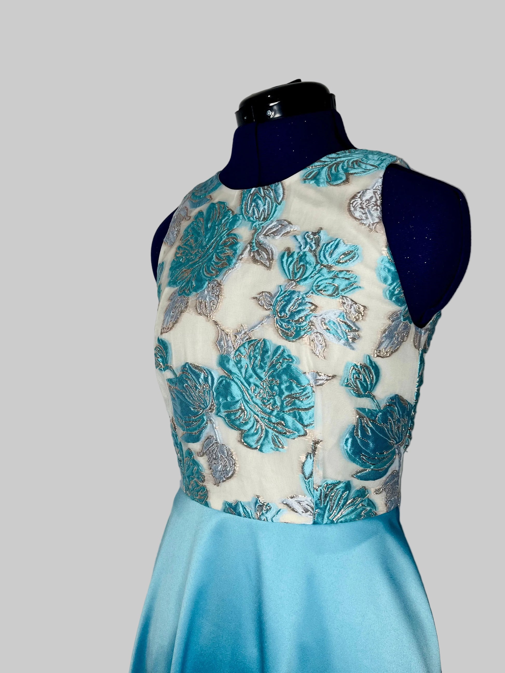 Dress with floral top and blue skirt on a mannequin against a white background