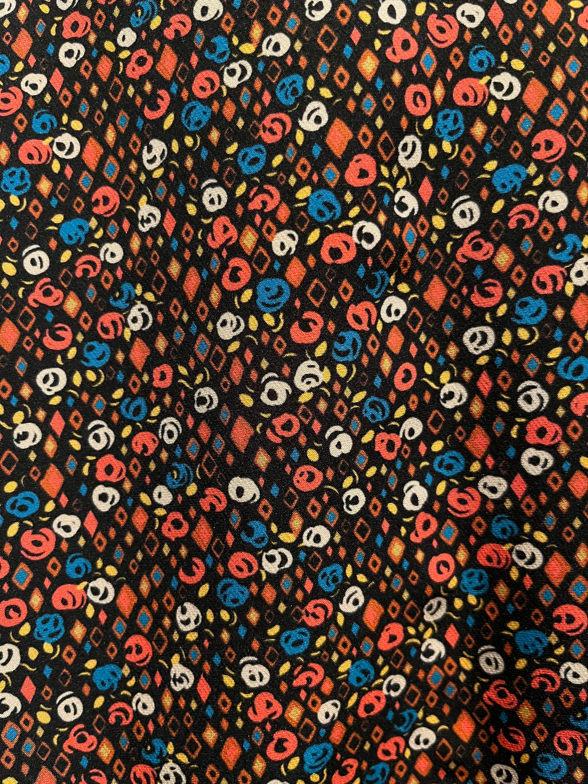 Patterned fabric with multicolor geometric design on a black background