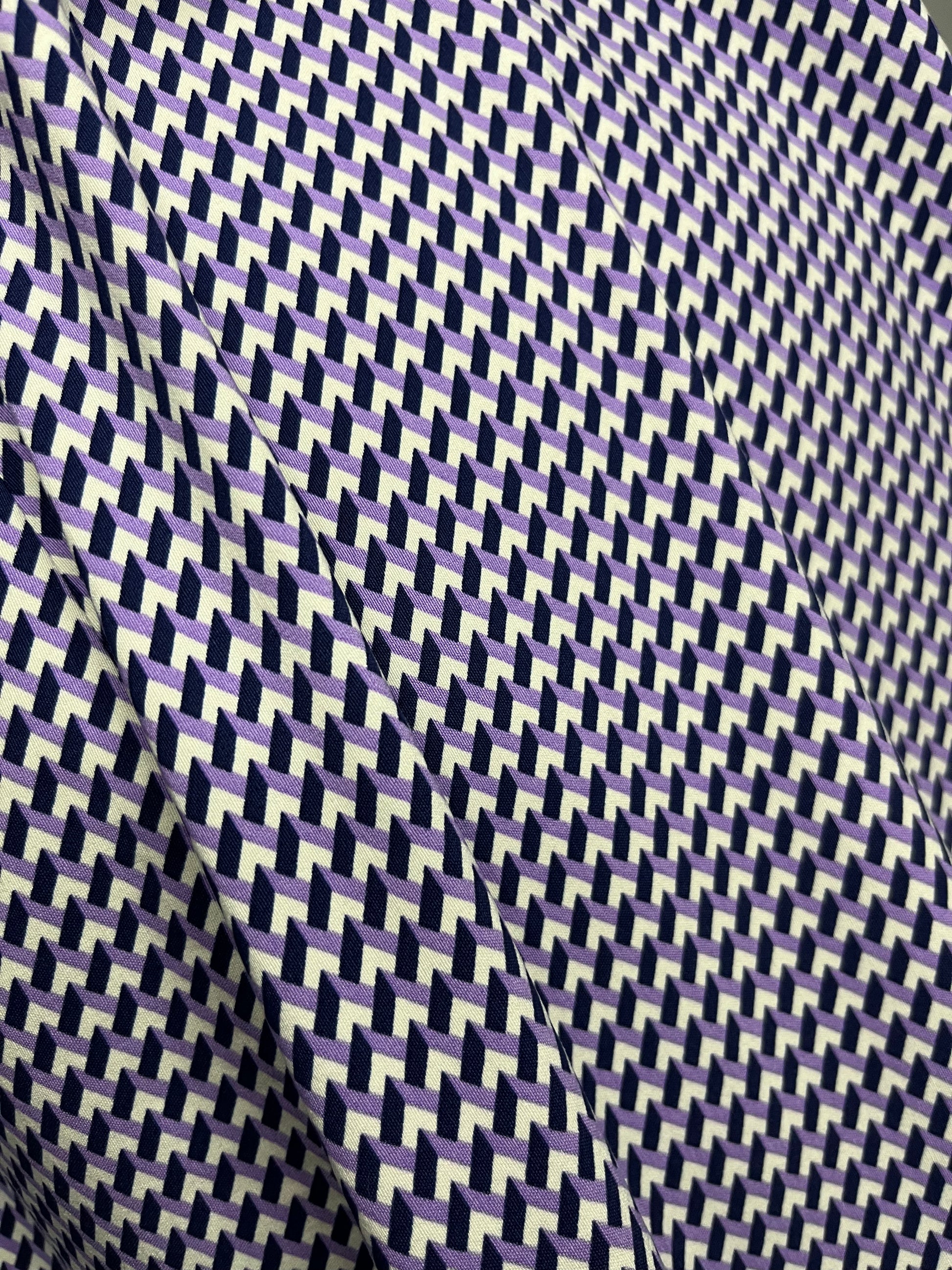 Fabric with a white, purple and navy geometric pattern.