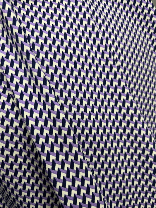 Fabric with a white, purple and navy geometric pattern.